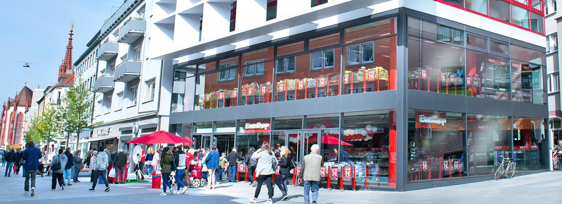 shop, storefront, glass facade, red accents, pedestrian street